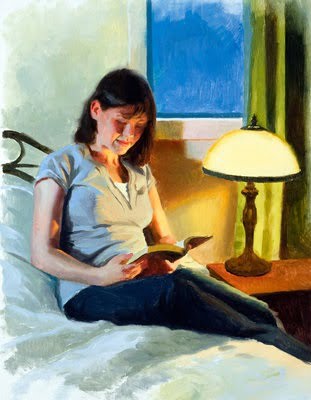Woman sitting on bed reading the Bible