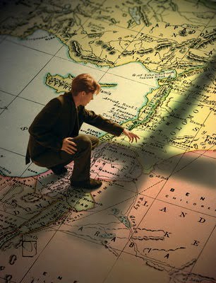 Young Man Standing on Big Map