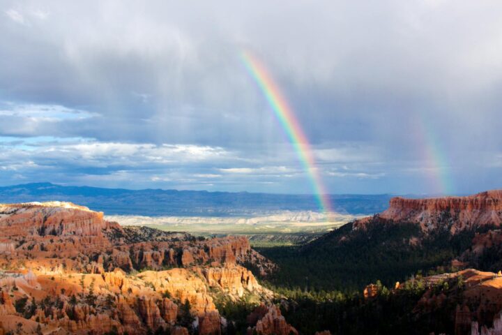 Spectacular double rainbow arches over Bryce Canyon's unique geological formations.