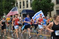 people holding american flag during daytime