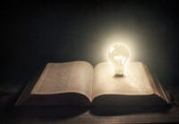 Glowing Light Bulb on top of a Bible